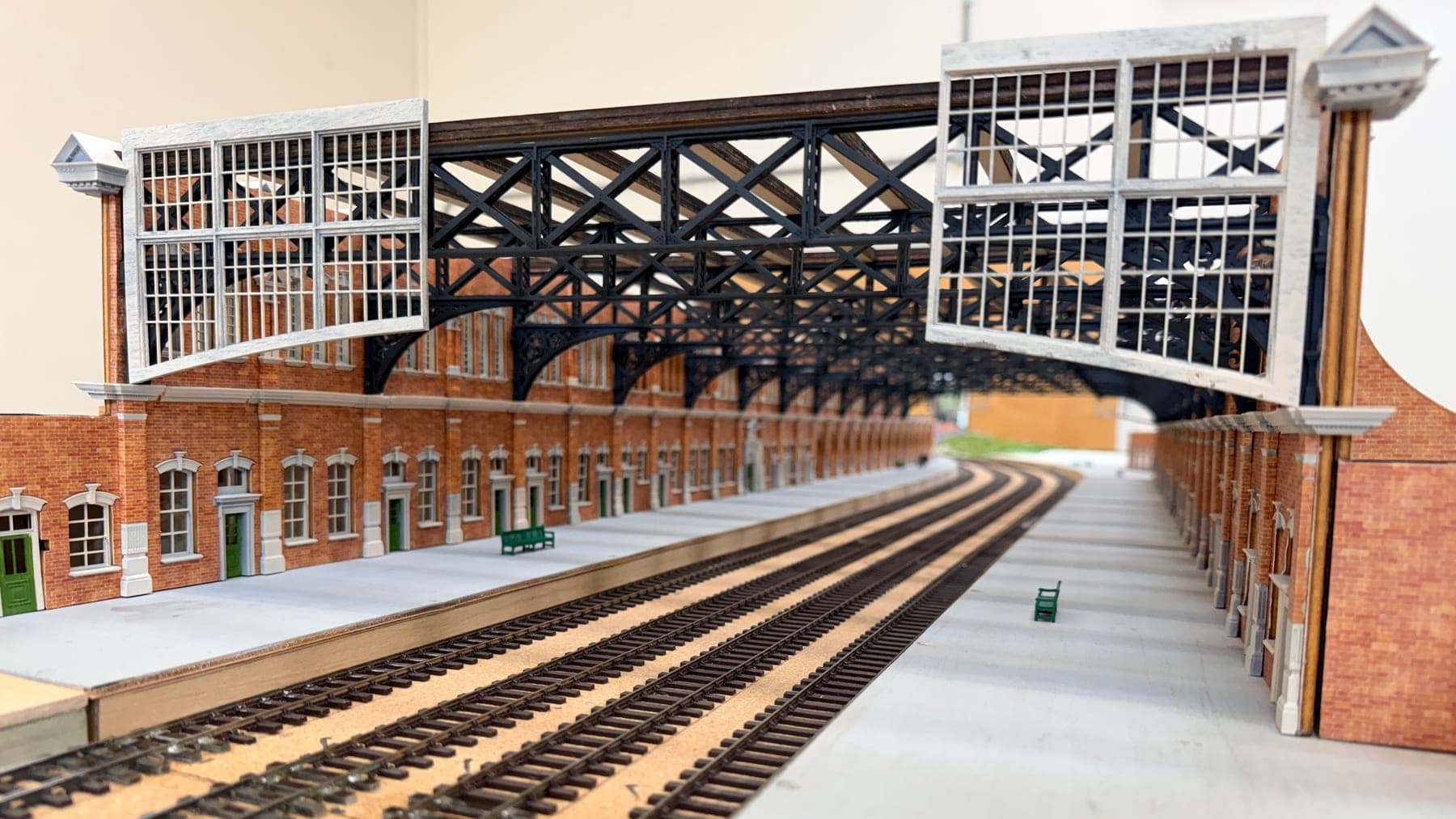 Looking down the platforms under the great trainshed roof, with its glazed end screens and brick walls of arched windows