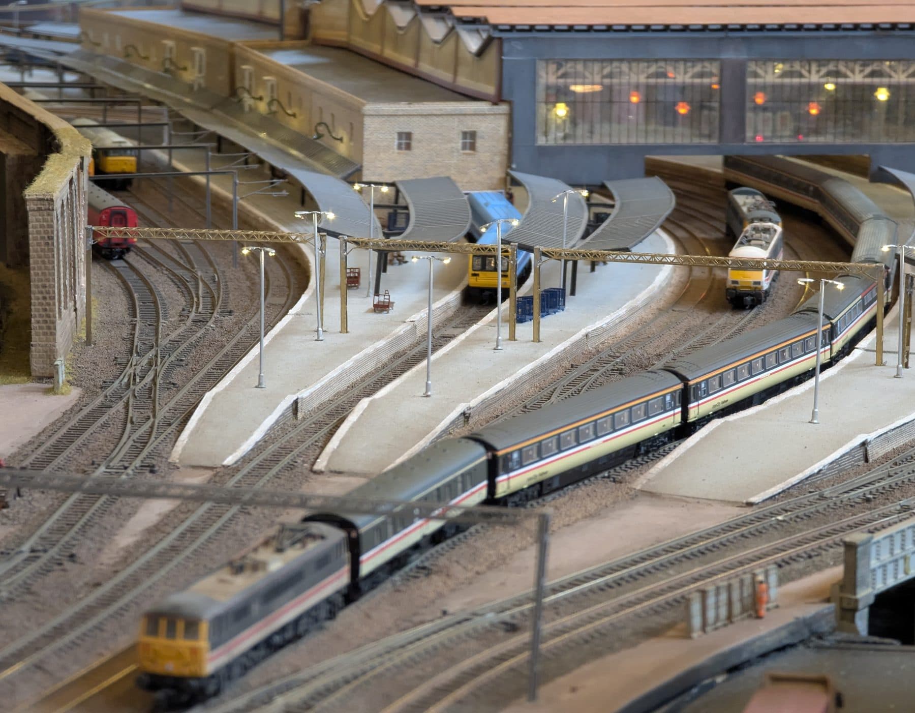 InterCity trains at the curved platforms of the station, under the canopies